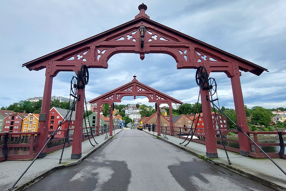 The red Gamle bybro (old town bridge) in Trondheim, with the Kristiansten Fortress in the distance.