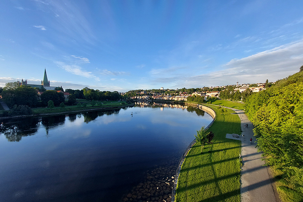 Image: A view of the meandering Nidelva river from Elgeseter Bridge, with Nidaros Cathedral on the left, Kristiansten Fortress in the distant centre, and the NTNU Gløshaugen campus on the right.